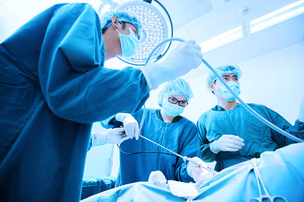 A group of surgeons performing surgery in an operating room. The best piles surgeon in Kota.